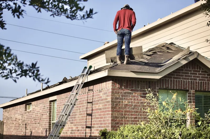 Professional roofer working on a residential roof in Scituate
